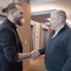 Thumbnail image: Kody Green shakes hands with Craig Jones, LCSW